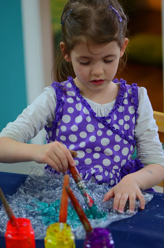 Girl painting on bubble wrap