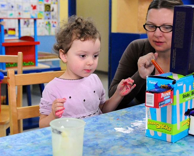 girl and her mom working on their sculpture together